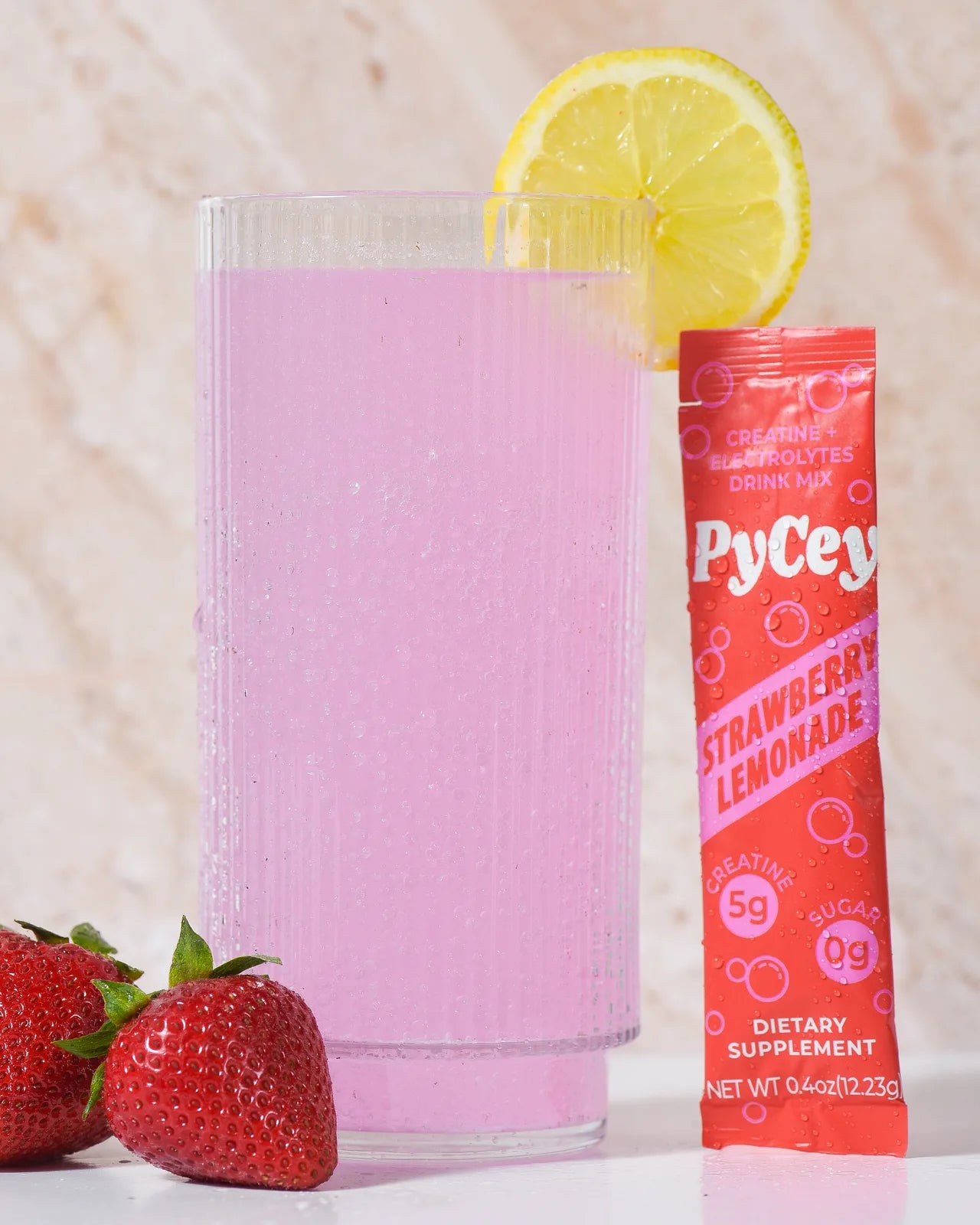 Glass of PyCey creatine drink with tiny bubbles keeping the creatine suspended